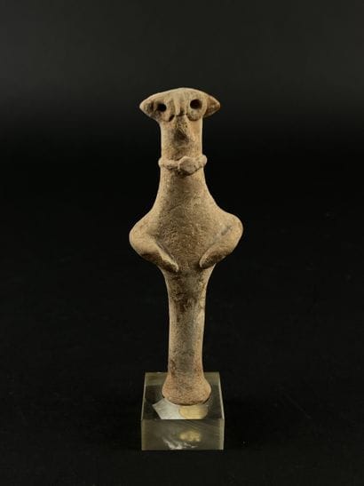 Anthropomorphic idol wearing a necklace....