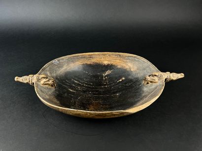 Wooden bowl decorated at the ends with two...