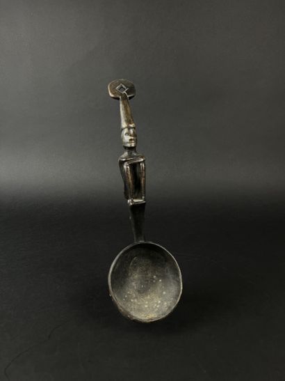 Ladle. The handle is decorated with a seated...
