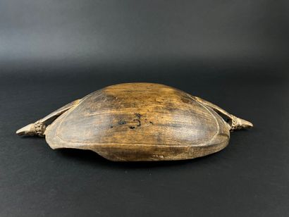 Wooden bowl decorated at the ends with two...