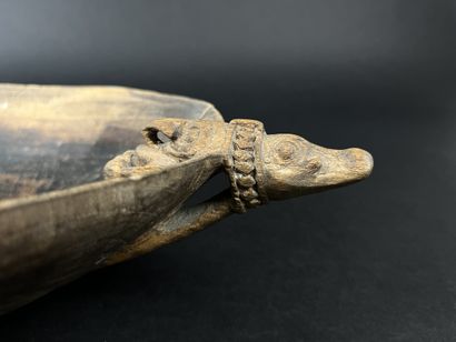 Wooden bowl decorated at the ends with two...