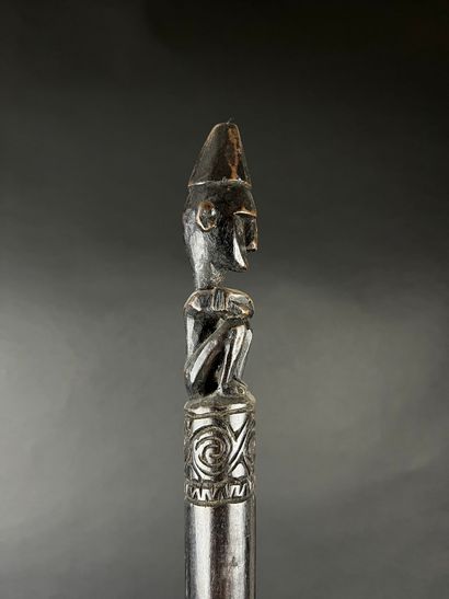 Command baton depicting a kneeling figure...