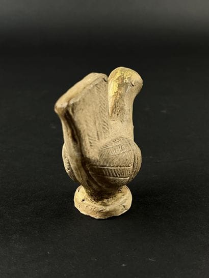Statuette representing a stylized bird. Terracotta,...