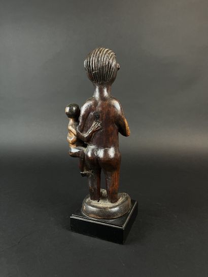 Standing mother with child on her left hip....
