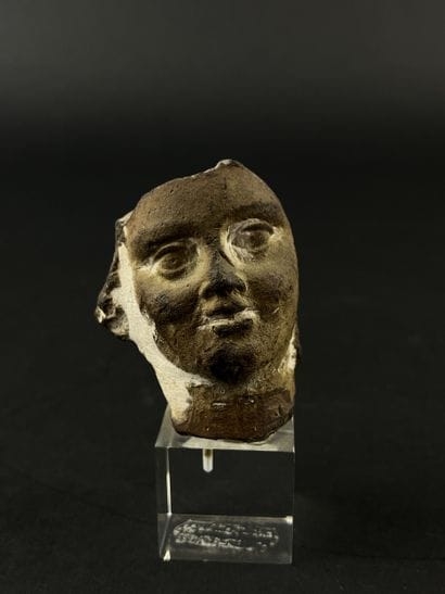 Head from a statuette. Terracotta, visible...