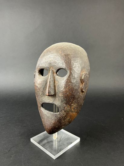 Shamanic mask with human face, oval shape,...