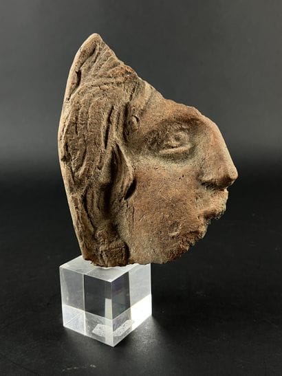 Fragmentary votive head. Terracotta, visible...