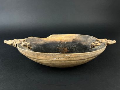 Wooden bowl decorated at the ends with two...