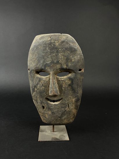 Rectangular shamanic mask with human face....