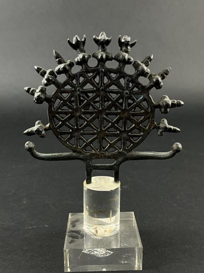 Ornament in the form of an openwork disk...