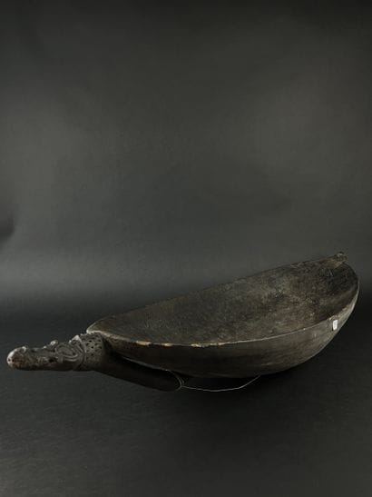 Large wooden bowl decorated at the ends with...
