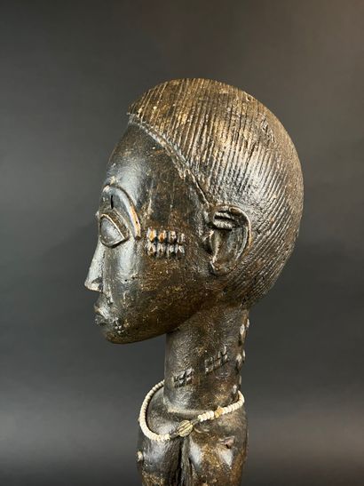 Male statuette depicted standing with arms...