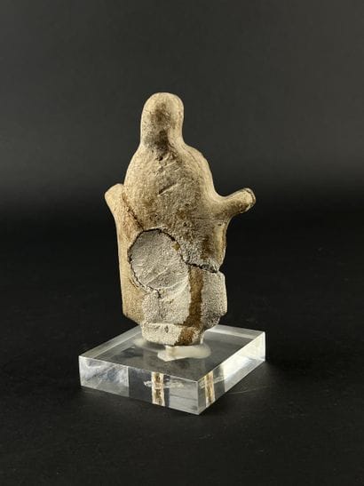 Statuette depicting a cape-clad figure with...