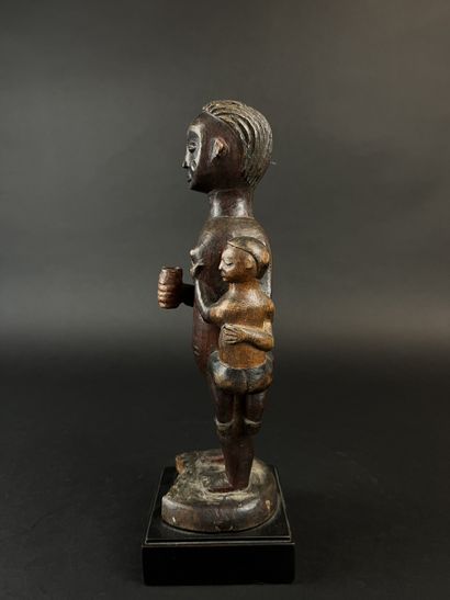 Standing mother with child on her left hip....