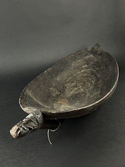 Large wooden bowl decorated at the ends with...