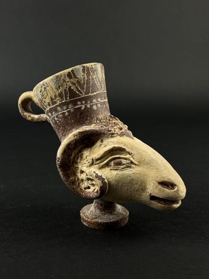 Lot consisting of a zoomorphic askos, a ram-head...