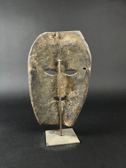 Rectangular shamanic mask with human face....
