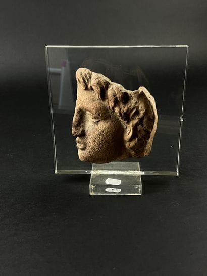 Fragmentary votive head of a young man. Terracotta....
