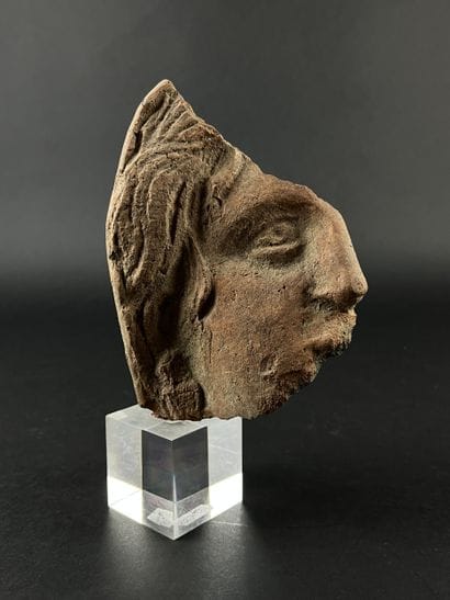 Fragmentary votive head. Terracotta, visible...