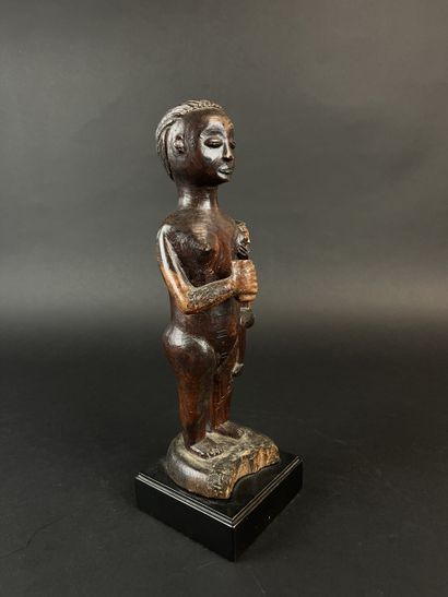 Standing mother with child on her left hip....