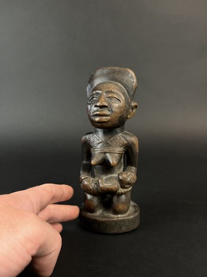 Kneeling mother with child on her lap. Wood...