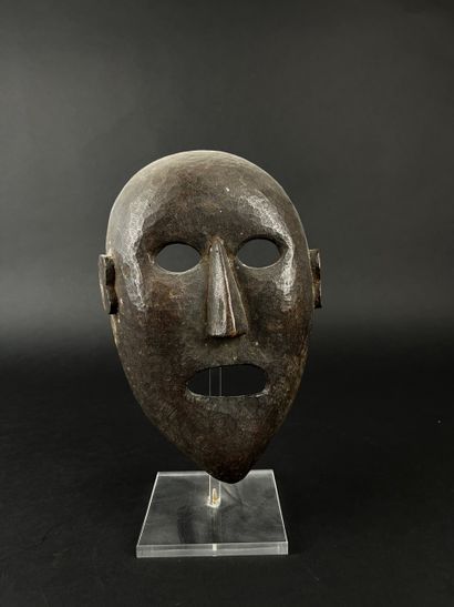 Shamanic mask with human face, oval shape,...