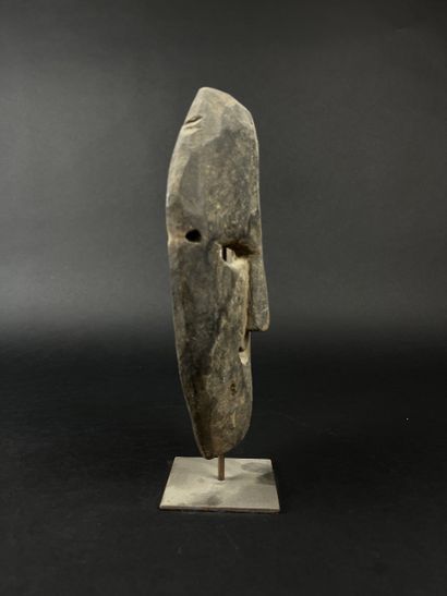 Rectangular shamanic mask with human face....
