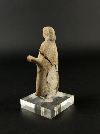 Statuette depicting a cape-clad figure with...