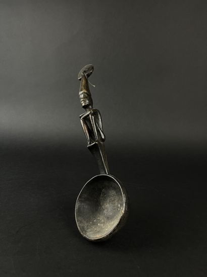 Ladle. The handle is decorated with a seated...