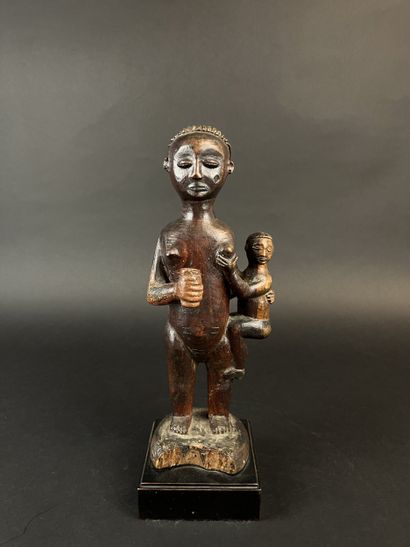 Standing mother with child on her left hip....
