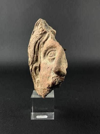 Fragmentary votive head. Terracotta, visible...