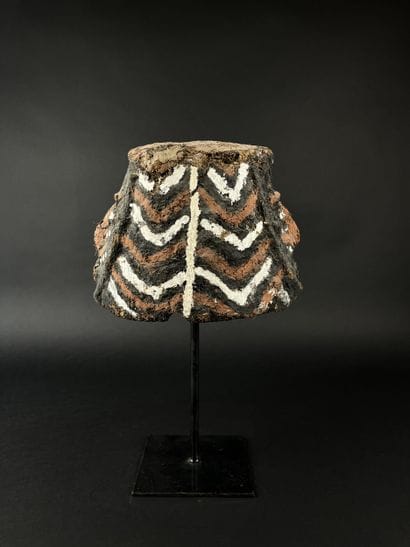 Janus helmet mask, depicting two human heads....