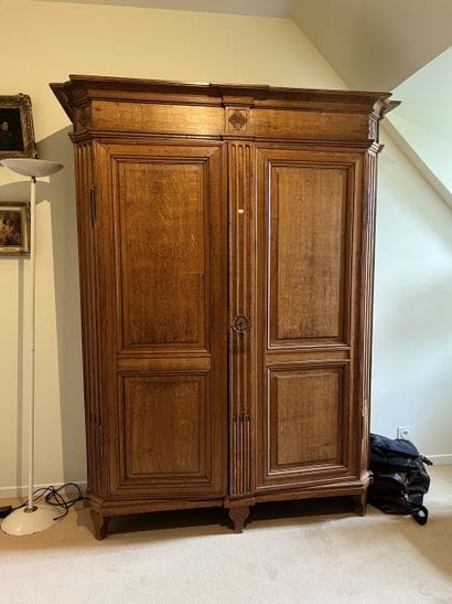 Molded and carved oak armoire. Opens to two...