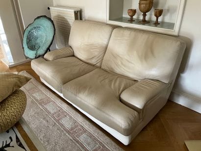Two two-seater sofas in beige leather, with...