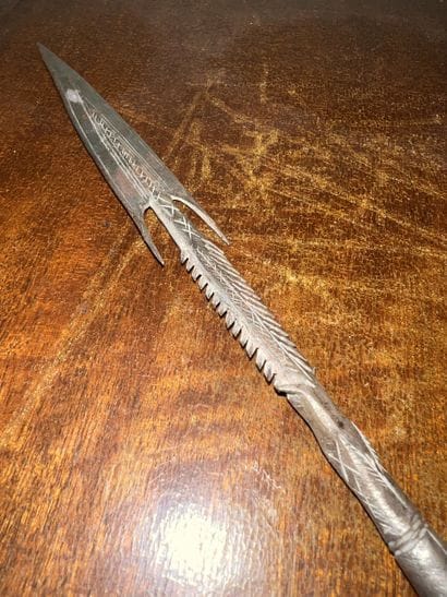 Iron spear point engraved with stylized motifs....