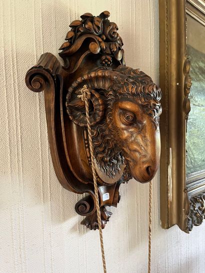 Walnut wall lamp featuring a ram's head on...