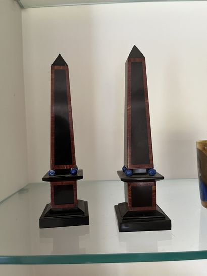 Pair of small obelisks on molded marble base...