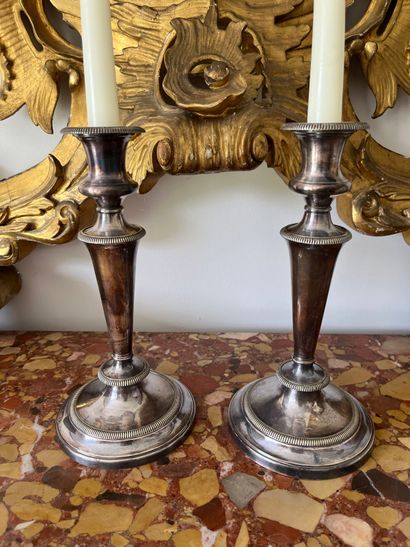 Pair of silver-plated candlesticks. The shaft...