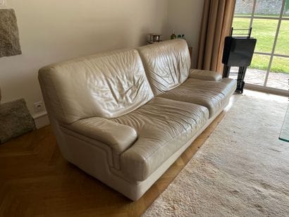 Two two-seater sofas in beige leather, with...