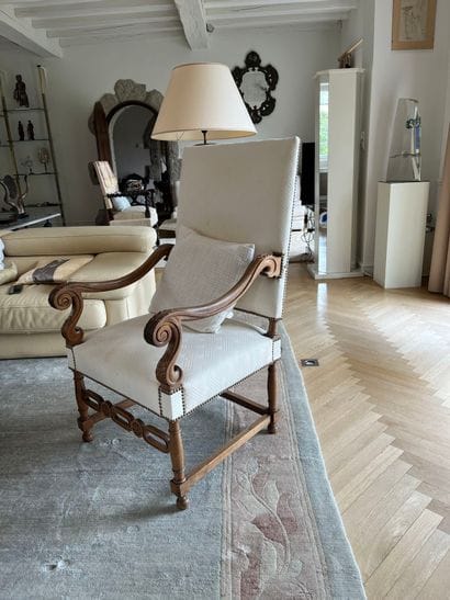 Suite of three molded and carved walnut armchairs,...