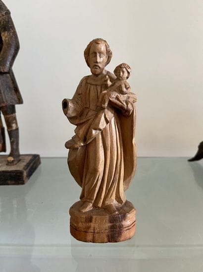 Carved limewood man carrying a child 19th...