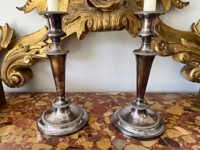 Pair of silver-plated candlesticks. The shaft...