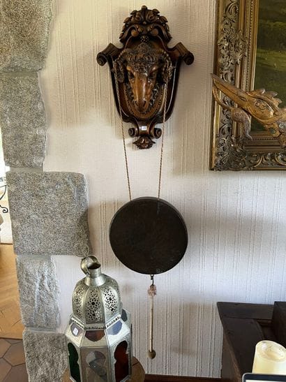 Walnut wall lamp featuring a ram's head on...