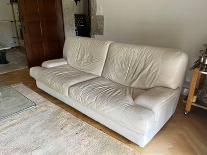 Two two-seater sofas in beige leather, with...