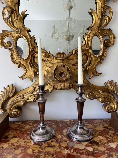 Pair of silver-plated candlesticks. The shaft...