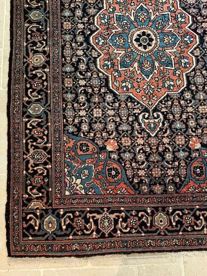 Hand-knotted wool rug decorated with a central...