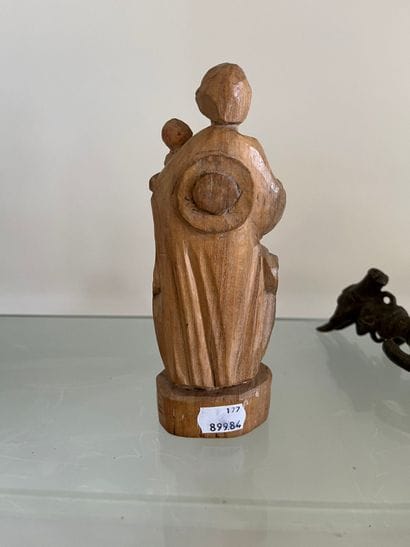 Carved limewood man carrying a child 19th...