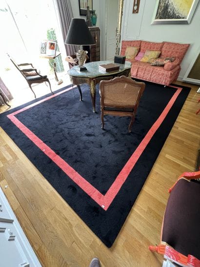 Black carpet with coral braid border. 
Contemporary...