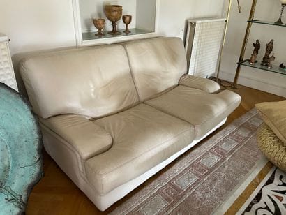 Two two-seater sofas in beige leather, with...