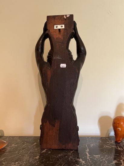 Sconce sculpture in stained oak representing...